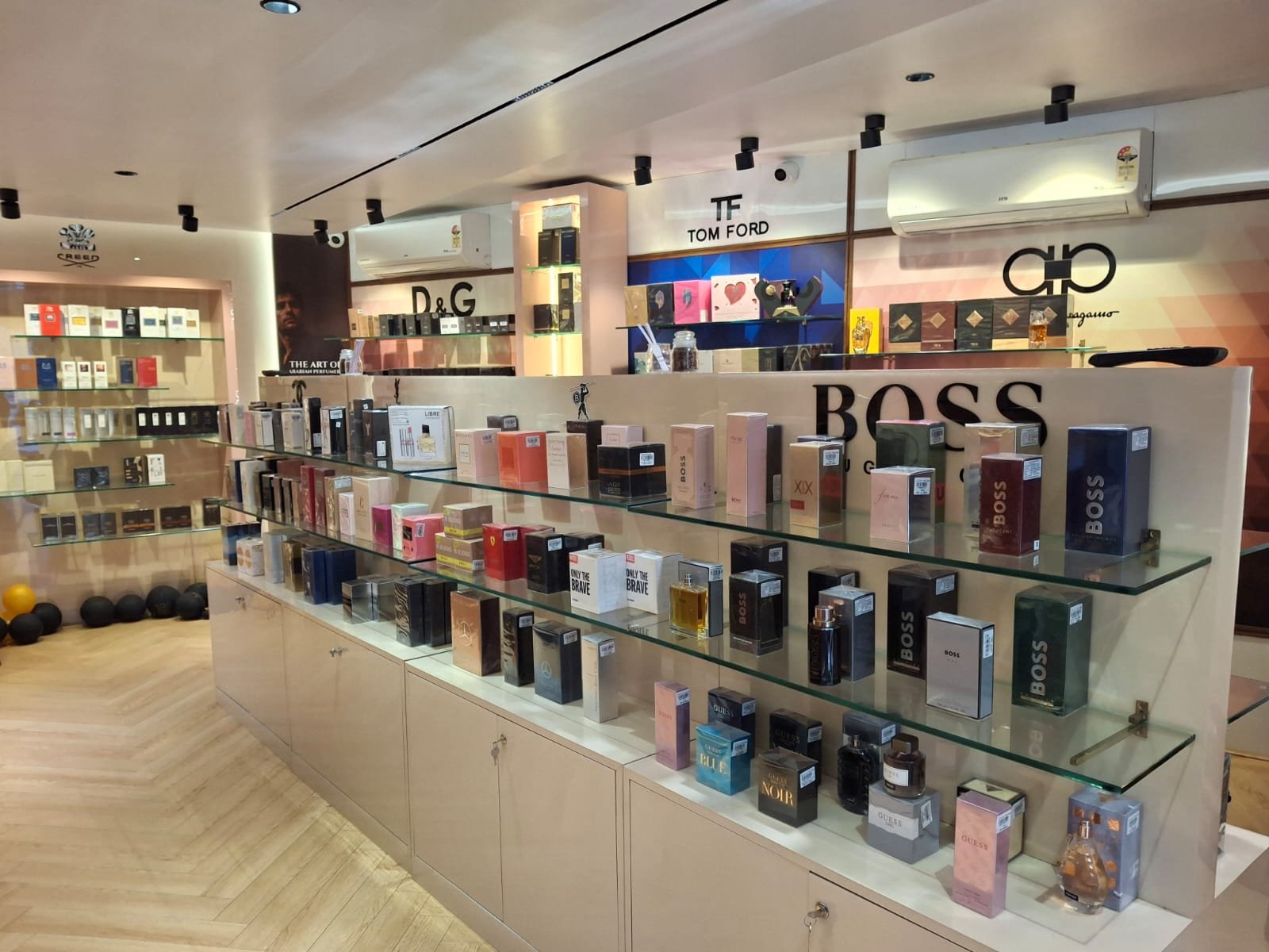 Infinity Perfumes store interior — Tom Ford, Chanel, Gucci wall